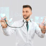 Front view of doctor measuring heartbeat on virtual 3D projection with strethoscope. Selective focus of digital tactile charts screen, man touching virtual icon. Concept of digitalization, medicine.