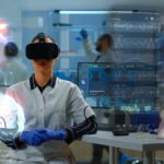 Scientific specialist in research lab wearing VR goggles using high tech equipment and wired sensors to do medical study. Healthcare practitioner using virtual reality technology to visualize datasets